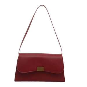 Classic deep red leather underarm baguette bag with elegant golden metallic lock closure