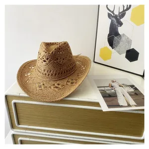 Detail of khaki straw cowboy hat with intricate diamond-shaped hollow-out patterns