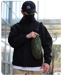Detail of army green hard shell crossbody bag showing geometric 3D molded waterproof surface