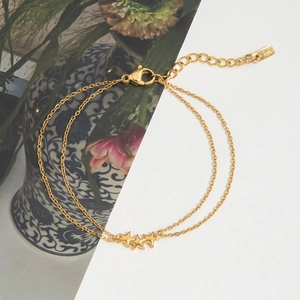 Detailed view of golden double-layer stainless steel star bracelet with adjustable lobster clasp