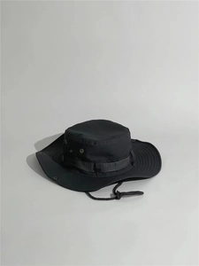Detail of a black outdoor boonie hat featuring metal eyelets and adjustable chin strap