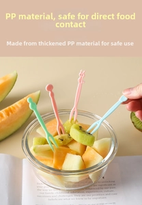 Close-up of food-grade plastic fruit picks with cute rabbit and sphere decorations