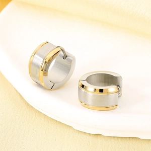 Detail of dual-tone brushed silver and polished gold C-shape stainless steel earrings