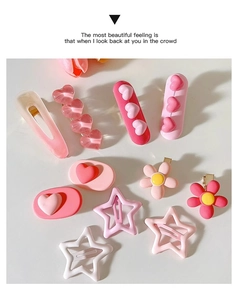 Close-up of pink heart and star shaped Y2K hair clips in various cute resin designs