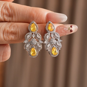Detailed close-up of zircon teardrop flower earrings with intricate silver setting