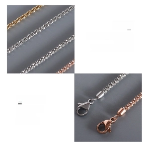 Macro detail of titanium steel chain set with lobster clasp and 18K gold plating