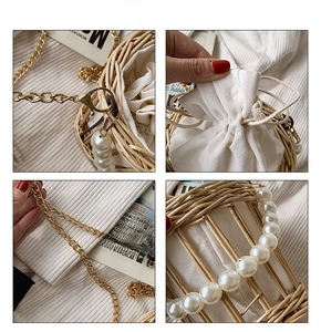 Close-up of woven straw bag showing pearl handle, gold chain strap and drawstring lining