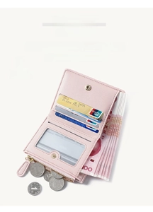 Detail of pink multi-slot mini wallet with card slots, ID window, and zipper coin pocket