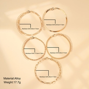 Detailed flat lay of a 5-piece gold alloy chain bracelet set with botanical shadows