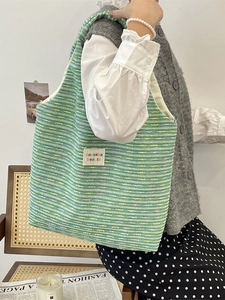 Green tweed woven tote bag with colorful threads and vintage aesthetic shoulder style