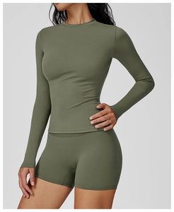 Close-up of olive green brushed long-sleeve yoga top and high-waist sports shorts fabric