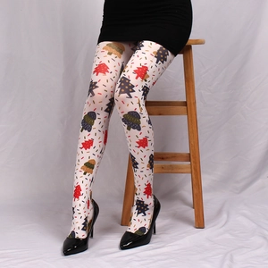 Close-up of white printed tights with colorful Christmas tree patterns and festive motifs