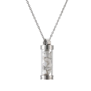 Detail view of a silver perfume bottle necklace filled with white crushed stones