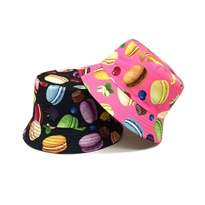 Kids printed bucket hats with macaroon patterns in black and vibrant pink colors