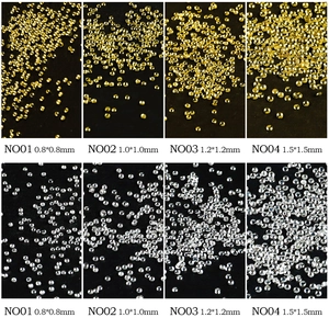 Mini gold and silver nail art metal studs in 0.8mm to 1.5mm sizes on black background