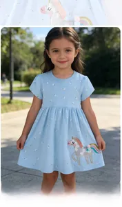 Detail of light blue girls dress with small floral print and unicorn embroidery