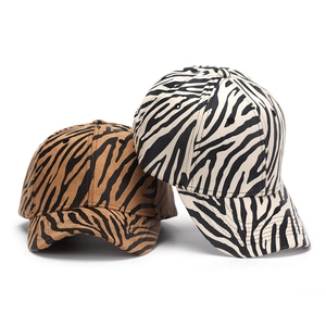 Zebra and tiger print baseball caps in khaki and cream white with curved brims