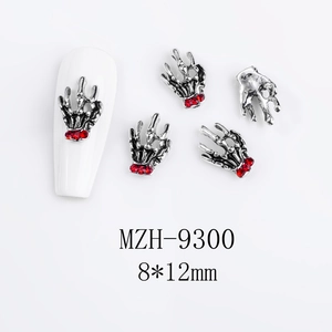 Detailed view of silver skeleton hand nail charm with red rhinestone, size 8x12mm
