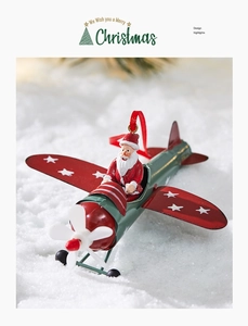 Detail of Santa Claus in a vintage metal airplane ornament on snowy background