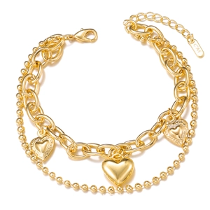 Double-layered golden bracelet with three heart pendants and elegant beaded chain details