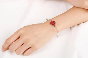 Detail showing an adjustable stainless steel chain with a red heart-shaped Love pendant