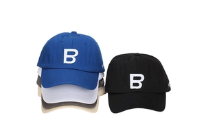 Detailed embroidery of letter B on multiple color canvas baseball caps stacked together