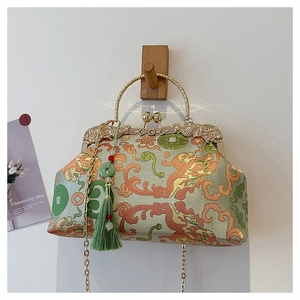 Detail of embroidered dragon pattern handbag with jade tassel and gold chain