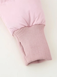 Detailed macro view of pink parka sleeve with ribbed windproof cuff and thumbhole feature