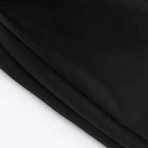 Macro detail of high-quality black pleated polyester fabric with silky smooth texture