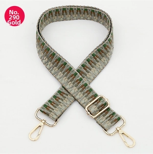 Close-up of ethnic style woven bag strap with geometric pattern and gold metal hardware