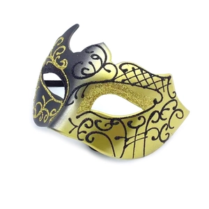 Detail of masquerade mask featuring gold glitter and black scrollwork patterns