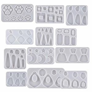DIY silicone resin molds for jewelry including cat paw and moon shapes on white background