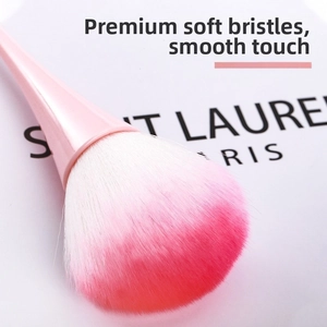 Close-up of pink gradient bristles on a large powder brush with dense synthetic fibers