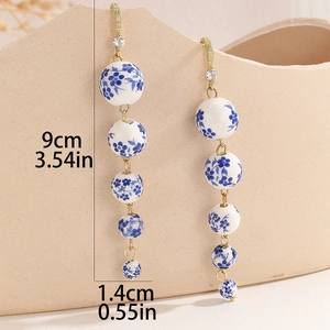 Blue and white porcelain bead tassel earrings with rhinestones for a vintage ethnic style
