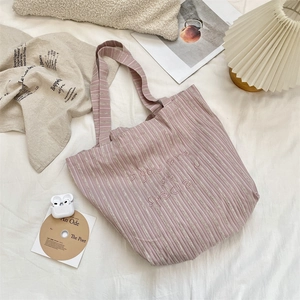 Detail of pink striped canvas tote bag with 'you are so special' embroidery text