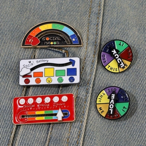 Detail of sliding social battery enamel pins on blue denim fabric background