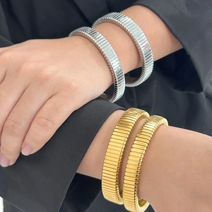 18K gold and silver Tubogas textured bracelets in stacked display for women