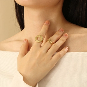Detailed view of layered hollow lines and hammered texture gold rings for women