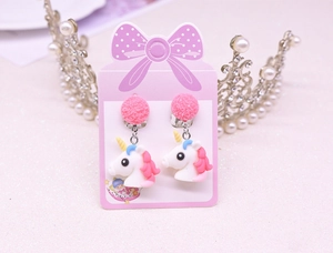 Detail of pink unicorn clip-on earrings for kids with glitter ball on bow card