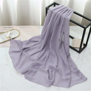 Detail showing lavender pearl chiffon scarf texture draped on a black metal hanger