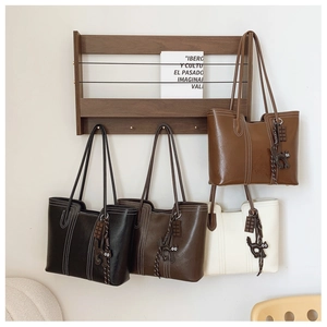 Detail view of four large capacity tote bags in black brown beige and caramel PU leather