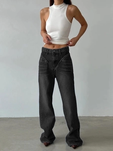 Detail of high-waist wide-leg denim jeans in washed charcoal grey with V-shaped stitching