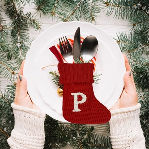 Deep red knitted Christmas stocking utensil holder with white embroidered letter P
