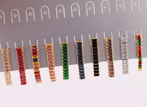 Detail shot of multi-colored rectangular zirconia drop earrings in ten vibrant colorways