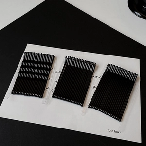 Detail view of black minimalist metal hair pins in wavy and straight designs