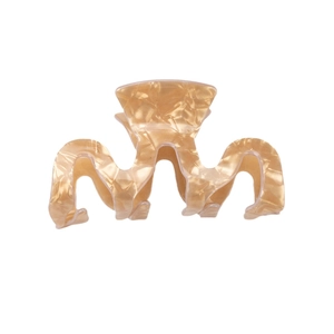 Elegant amber wave-shaped hair claw clip with glossy pearlescent finish for women
