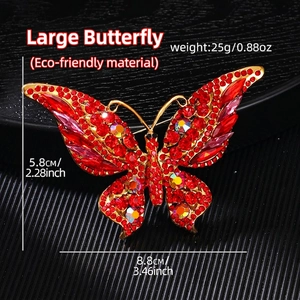 Large vintage butterfly brooch with red crystals and gold alloy finish, 8.8cm size