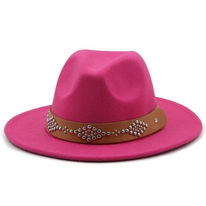 Detail of rose red wool jazz hat with brown studded leather band and silver rivets