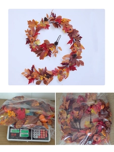 Detailed view of autumn maple leaf garland with pine cones and pumpkins for fall decor