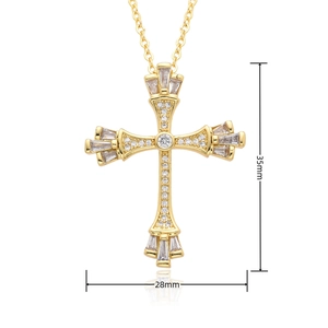 Detail view of a gold cross pendant necklace with clear zircons measuring 35mm by 28mm